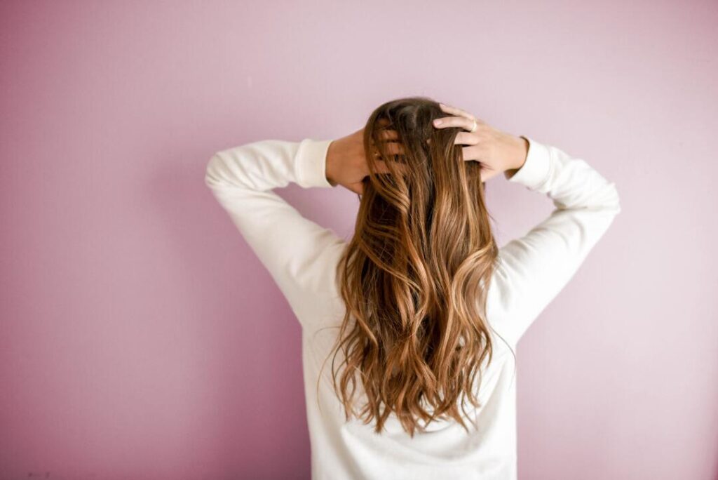 Back View of hair girl with both hands in her hair